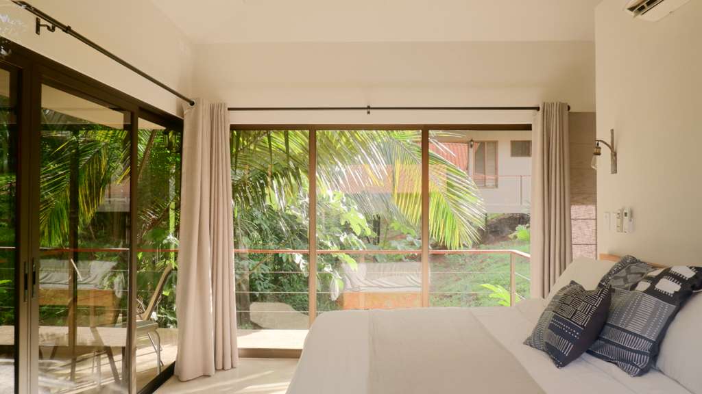 bedroom in the costa rica villa with sliding doors to the jungle